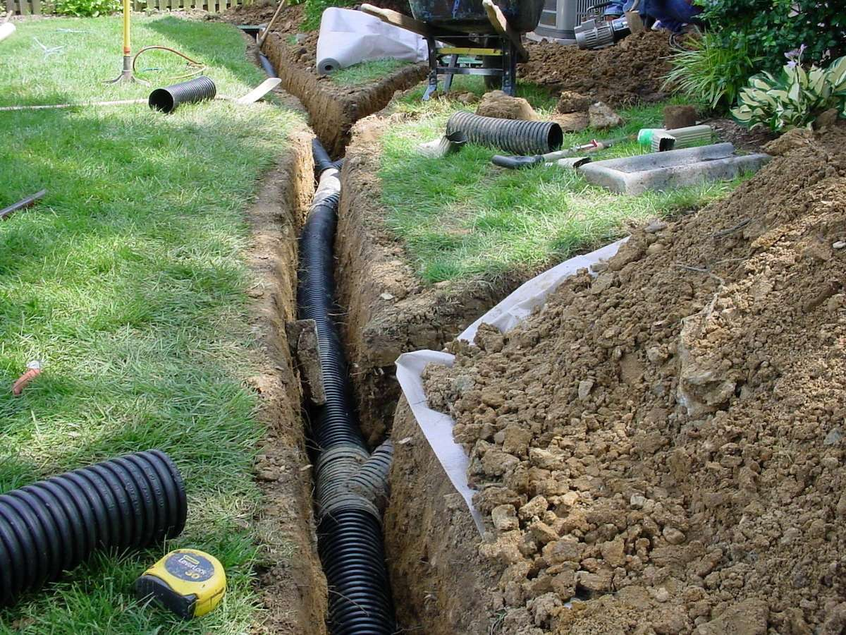 Weeping Tile Replacement project in North York — Drainage trench with perforated pipe and filter fabric installed in a residential yard
