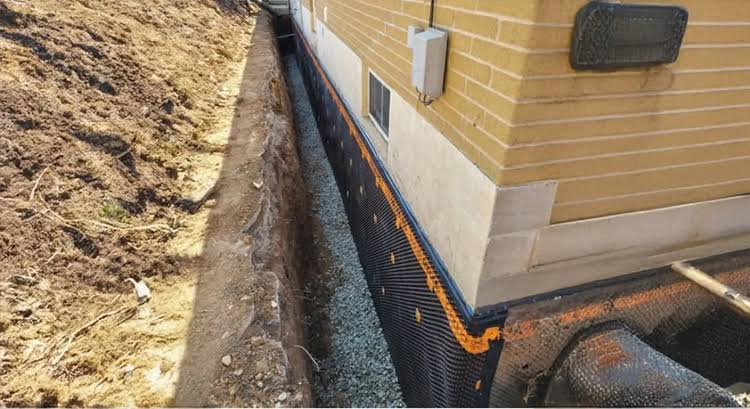 Exterior Waterproofing project in East York — Exterior foundation wall excavated to the footing with dimple membrane and new weeping tile in clear stone